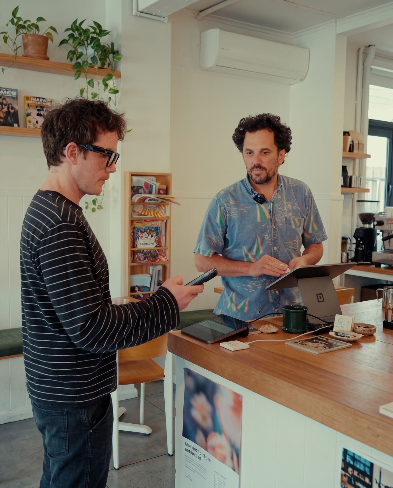 A customer and cafe owner at the counter with Receiptile beside their POS