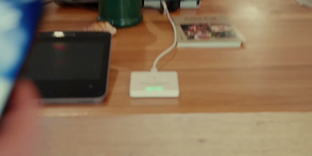 A customer taps their phone on a Receiptile tile to open their receipt